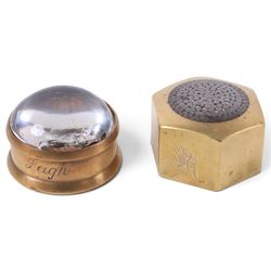 Two 1930s mining interest brass paperweights, comprising a hexagonal brass and steel example containing winding gear cables from the Wheldale Colliery and a smaller brass example with glass dome, advertising copper winding gear cables inscribed Anchor Cable Co, tallest H3cm