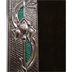 American Art Nouveau silver mounted photograph frame, of rectangular form, with oblique gadrooned rims, embossed iris flowers and vacant oval cartouche, interlaced with ribbons and green blue enamel, upon hobnail effect ground, with hardwood easel style support verso, stamped Sterling