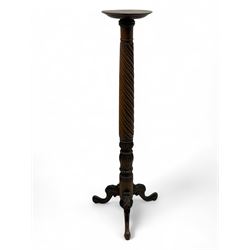 Late 19th century mahogany torchère stand, with circular top above a twisted and foliate c...