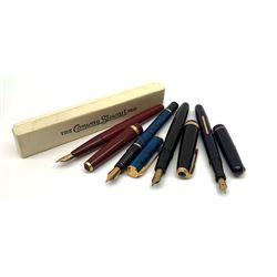 A group of four fountain pens, comprisin