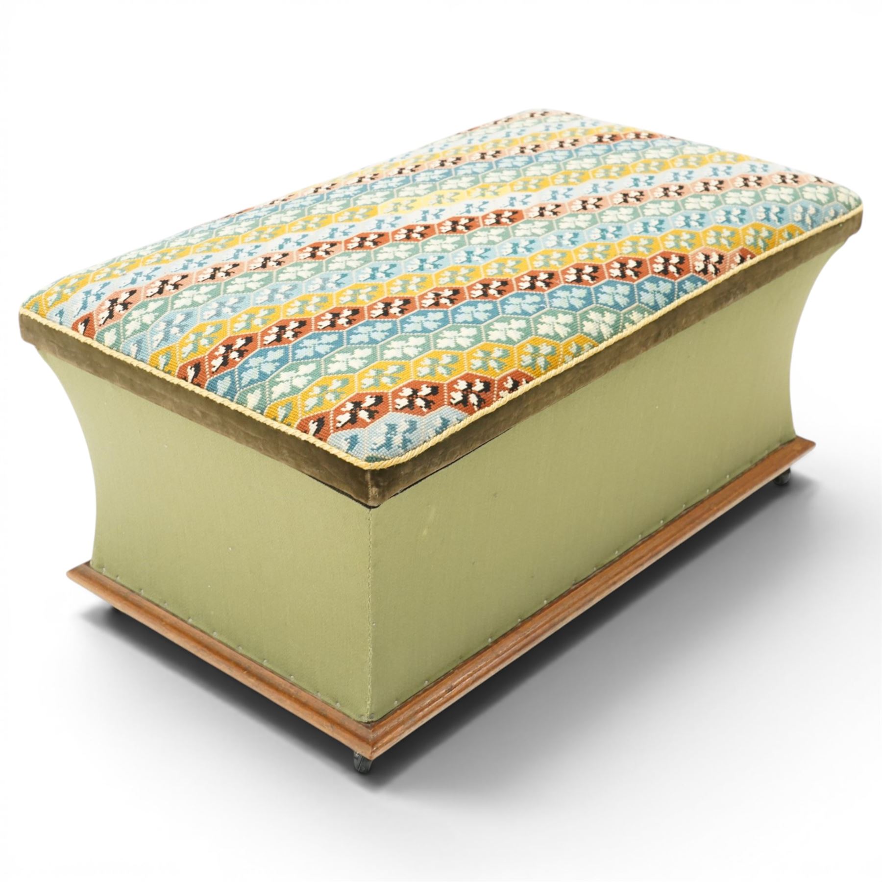 Victorian Ottoman with tapestry cover, with multicoloured geometric needlepoint cover, hinged to reveal a pink paper lined interior, the base covered in green velour fabric, raised on later castors