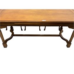 Late 20th century oak dining table, rectangular top with two draw leaf extensions, on turned supports united by moulded hayrake stretchers (180cm - 278cm x 90cm, H76cm); set of eight (6+2) oak dining chairs, shaped cresting rail over shaped splat back, upholster drop-in seat, on cabriole supports united by turned H-shaped stretchers 