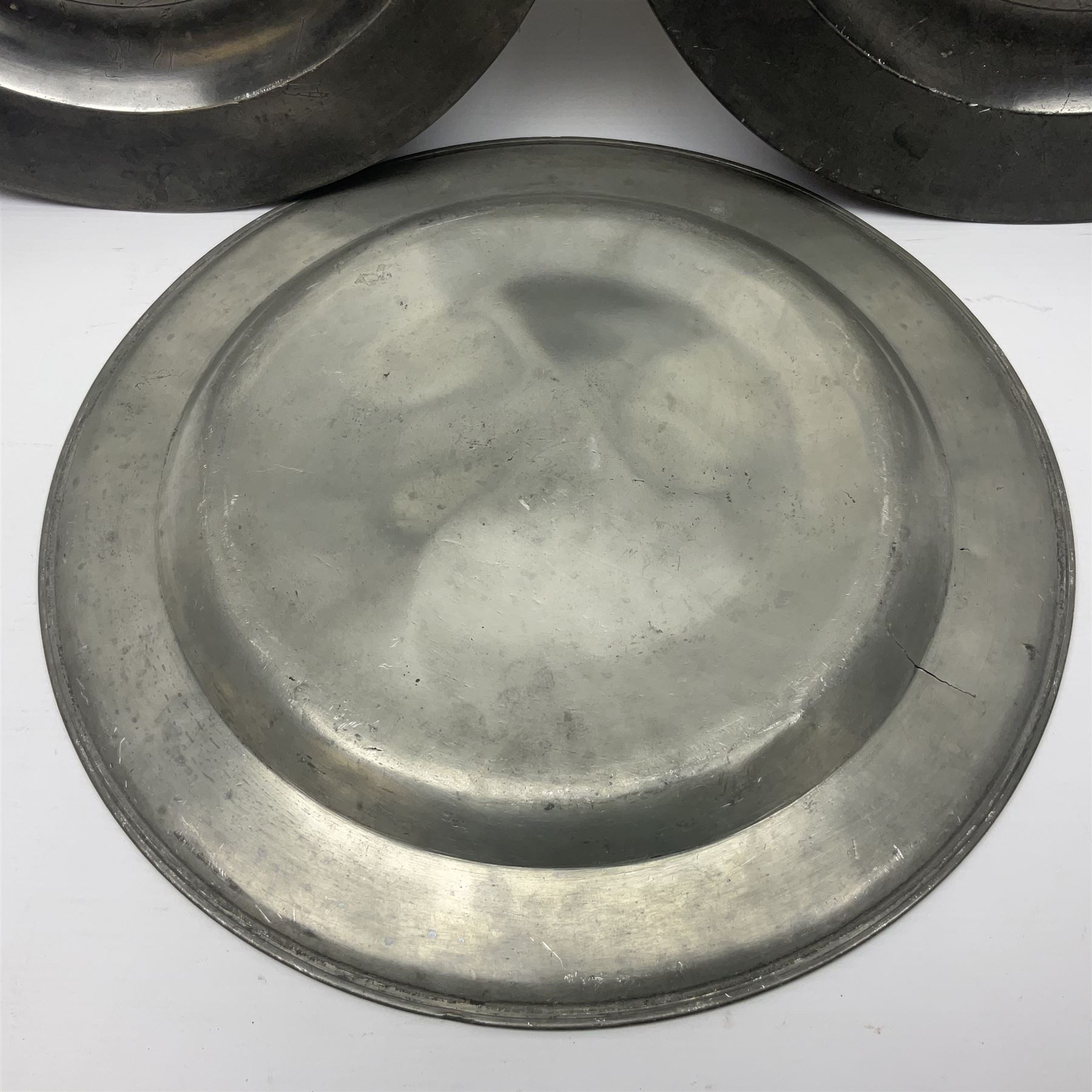 Group of seven 19th century pewter chargers, each of circular form with dished centre, two examples with touch marks verso, each approximately D39cm