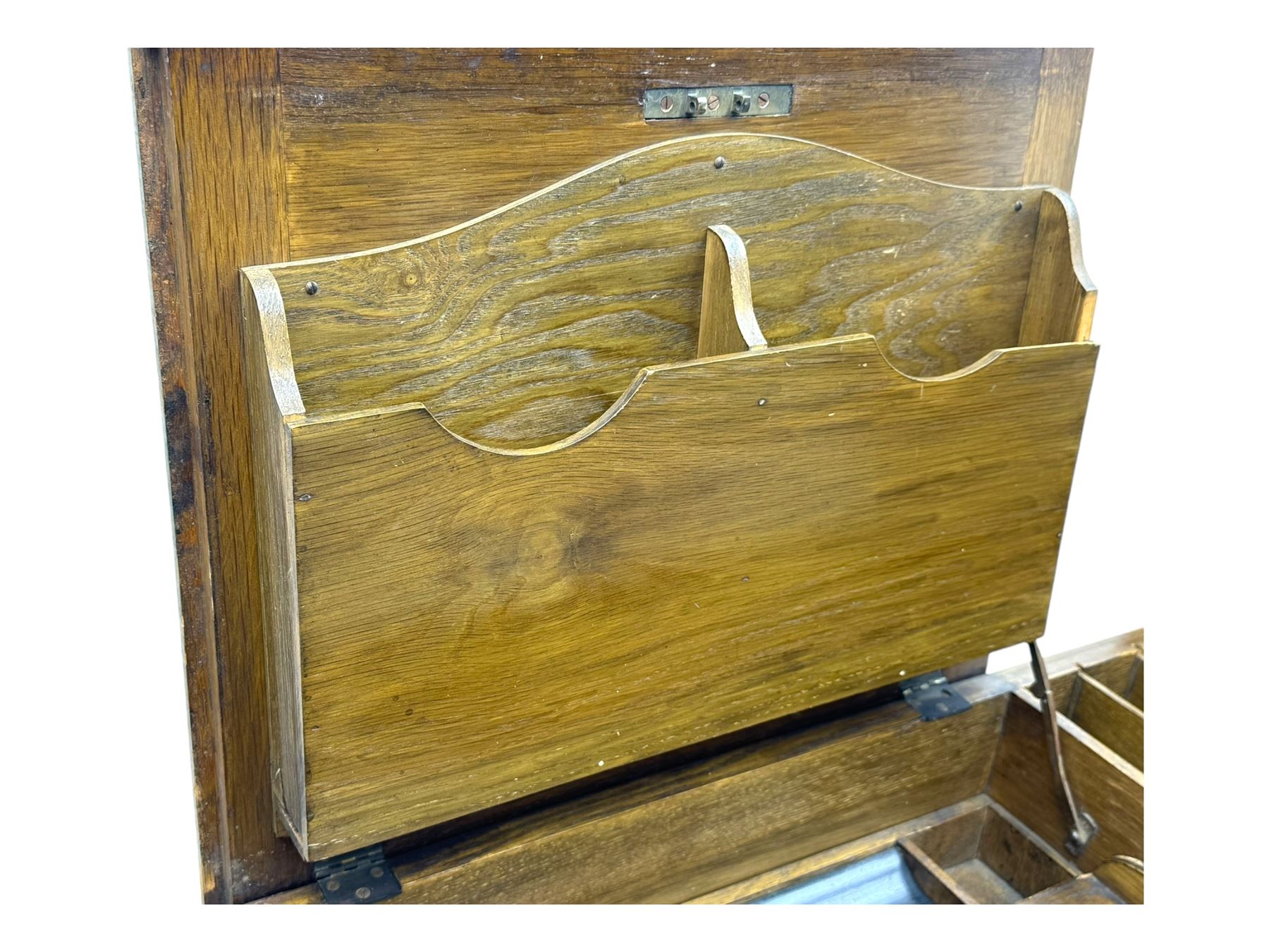 Edwardian oak metamorphic 'Britisher Writing Table', rectangular hinged top revealing correspondence compartments and hinged writing surface with underside storage, flanked by twin hinged compartments with dividers, on turned supports
