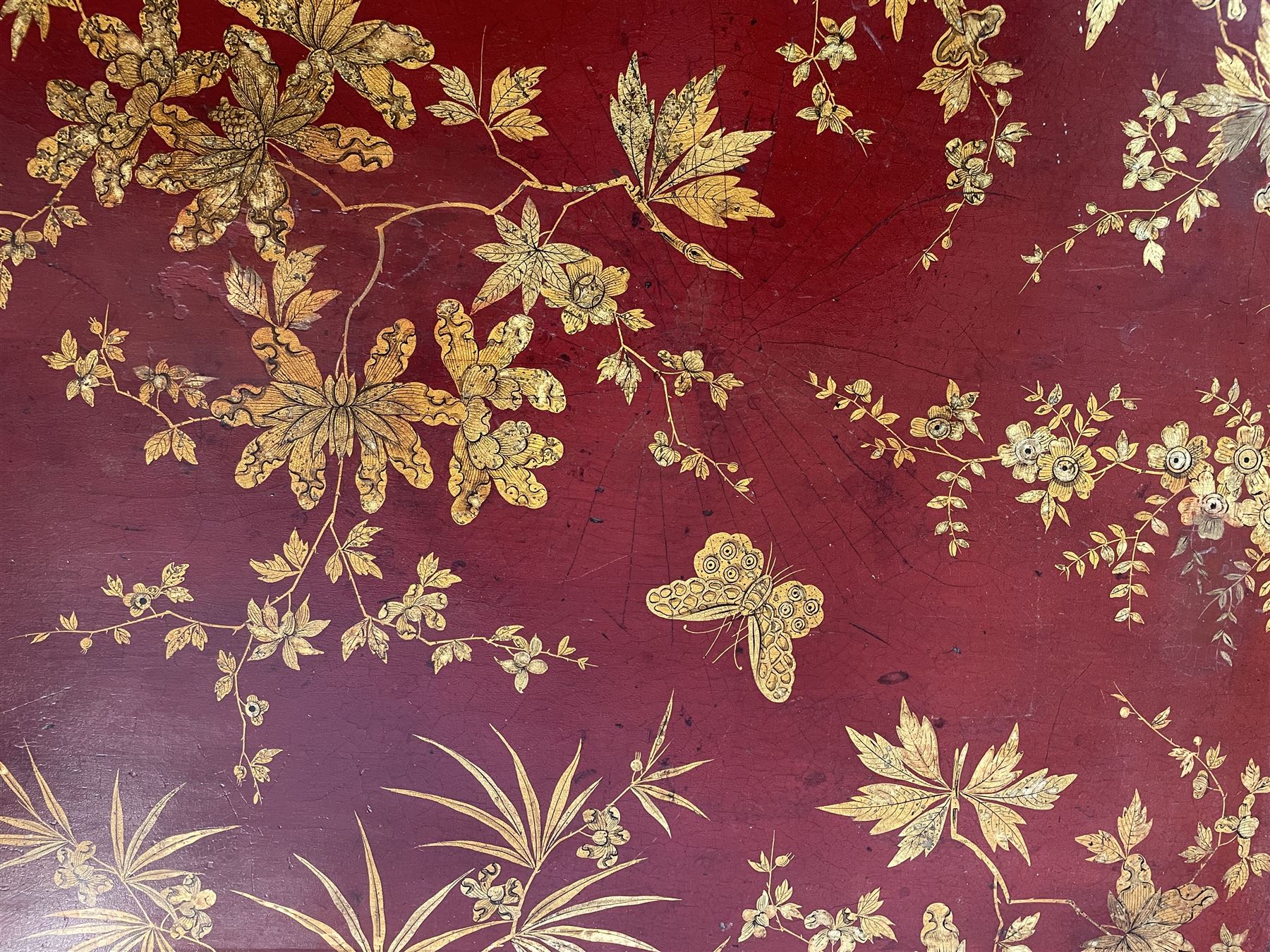 Early 19th century red lacquered papier-mâché tray by Clay of King Street Covent Garden, of rounded rectangular form, painted in gilt with large foliate sprays and butterflies, impressed verso CLAY KING ST COVENT GARDEN, W66.5cm D48.5cm