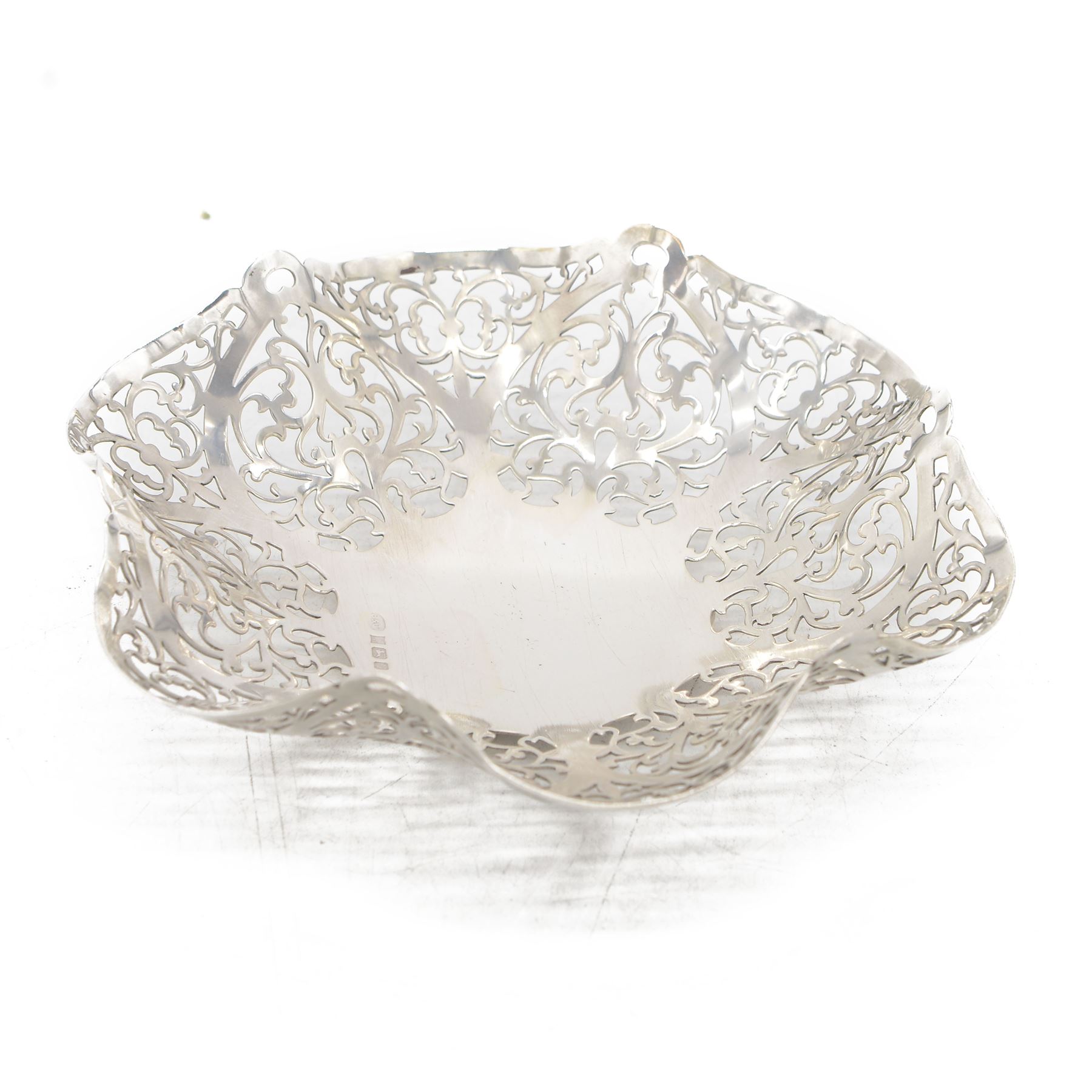 Mid 20th century silver bowl, of hexagonal form with scrolling pierced sides, upon three bun feet, hallmarked W I Broadway & Co, Birmingham 1962, W18cm