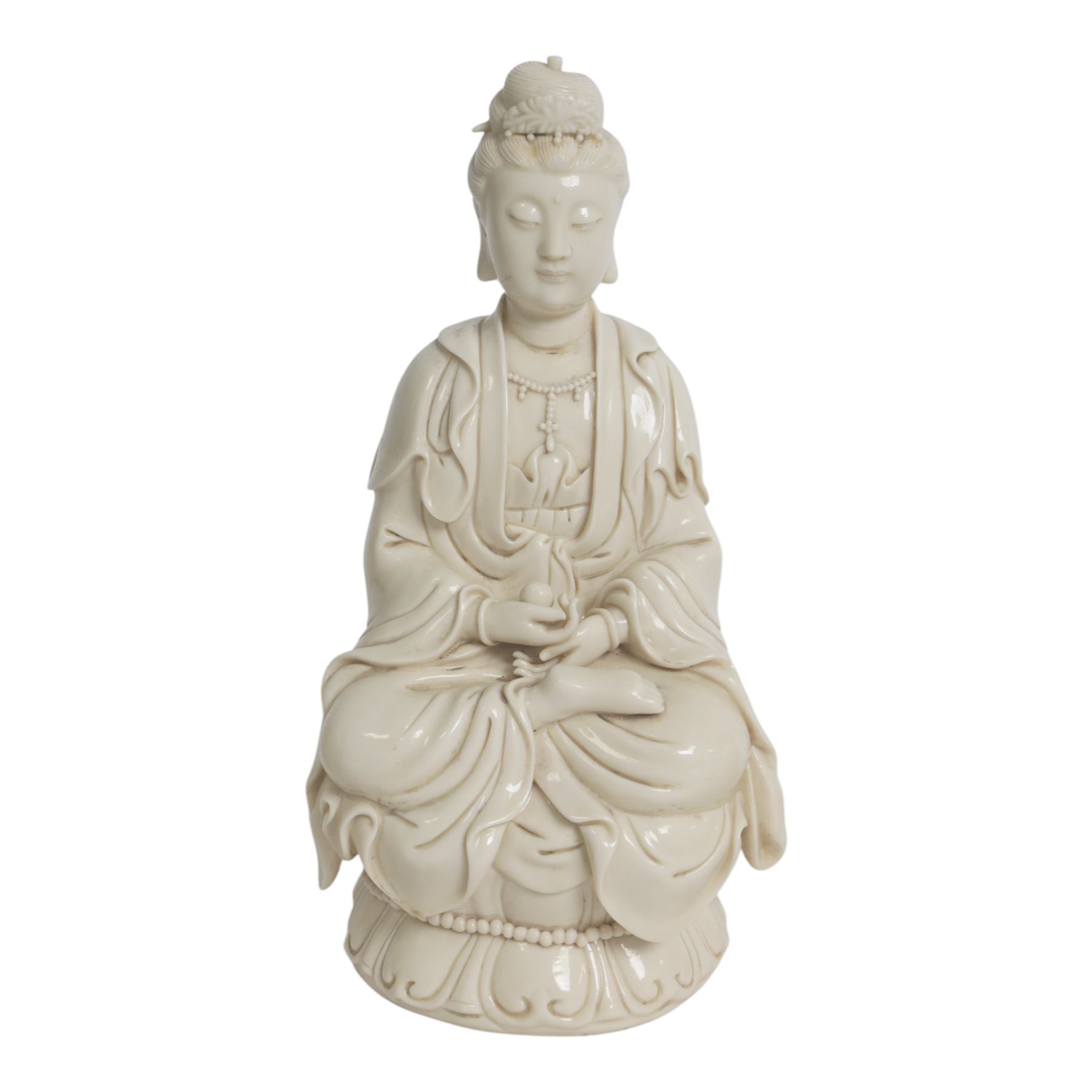 Three Chinese blanc de chine, each depicting Guanyin seated, Dehua province, two with double gourd and potters seal marks to the reverse 