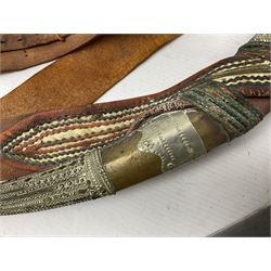 Saudi Arabian khanjar dagger with 29.5cm curving double edged  steel blade; white metal and copper mounted horn grip; in white metal mounted brass and leather scabbard incorporating embroidered leather wearing strap