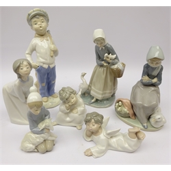  Lladro figures comprising two Angels, boxed, Shepherd Boy, boxed, Girl Kissing, Duck Seller & another and a similar style boy (7)  