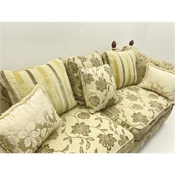 Grande Knole drop arm three seat sofa upholstered in pale fabric with raised floral pattern, with feather scatter cushions