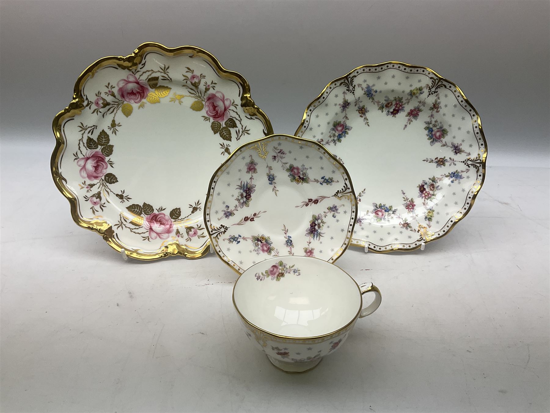 Coalport Revelry pattern tea and dinner wares, comprising nine dinner plates, four salad plates, eleven side plates, sauce boat and stand, ten teacups and ten saucers, and preserve pot and cover, together with a Coalport plate of shaped form decorated with pink roses, and a Royal Crown Derby Royal Antoinette pattern trio