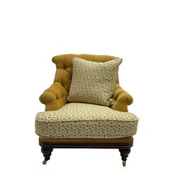 Victorian style armchair, upholstered in buttoned fabric with contrasting foliate pattern seat and scatter cushion, on turned front feet with castors