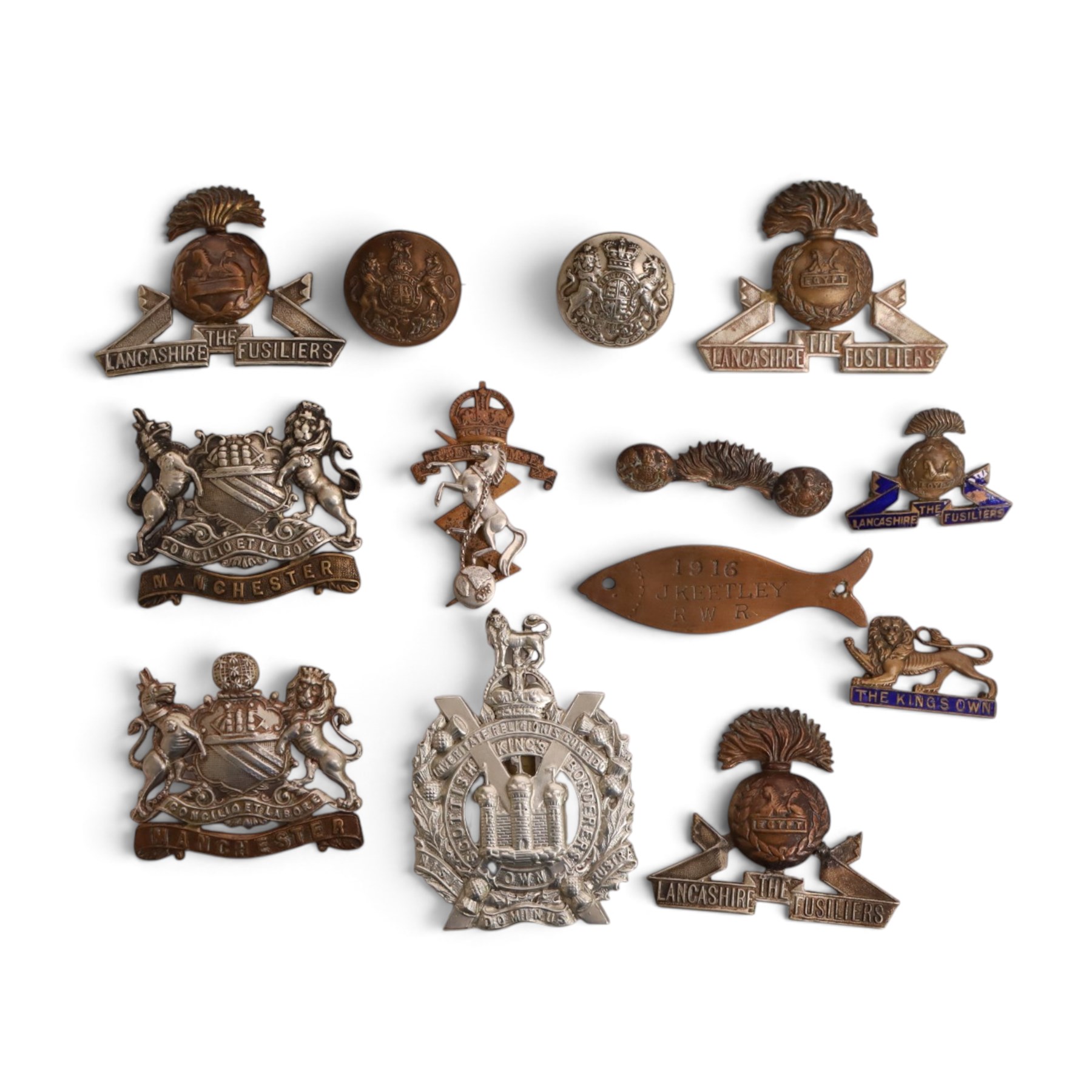  WWI Queen Mary 1914 Christmas tin, together with various cap badges including Lancaster Fusiliers, Manchester Regiment and King's Own Scottish Boarders  
