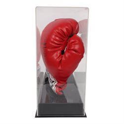 Muhammad Ali and George Foreman signed boxing gloves, two Everlast gloves the left hand glove signed by Ali and right signed by Foreman, both in black marker pen, in Perspex display case with plaque to base displayed with a further unsigned glove, each with Mounted Memories holographic stickers, case H36cm