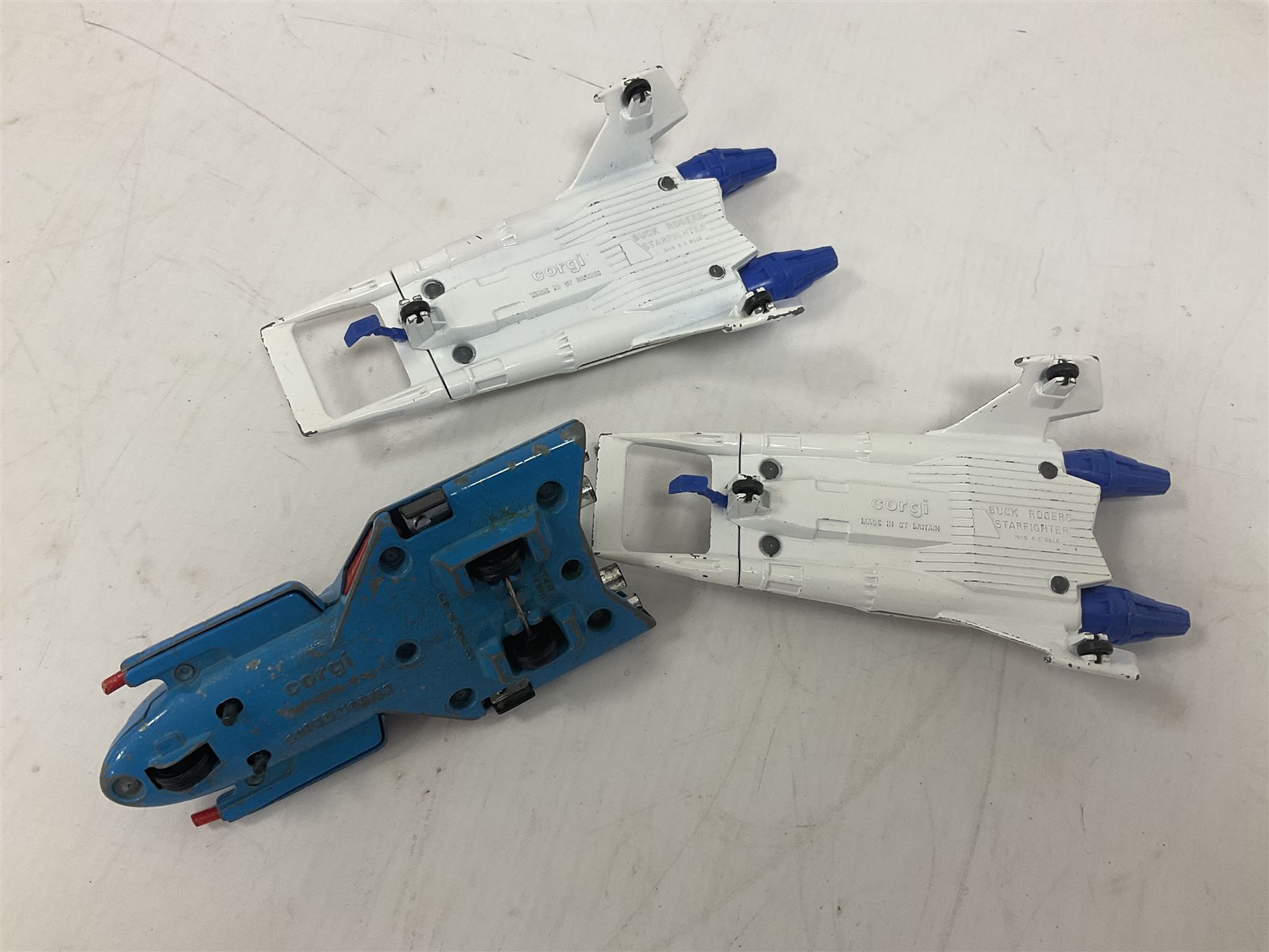 Corgi - seven unboxed and playworn TV/Film related die-cast models including Chitty Chitty Bang Bang with all four figures, Batmobile with both figures, Lady Penelope's FAB 1 with both figures, Superman Supermobile, two Buck Rogers Starfighters and The Saint's Volvo P.1800 (7)