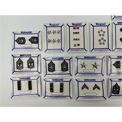 Fifty US rank badges and trade badges; WW2 and Vietnam period; predominantly on sale cards