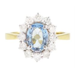 18ct gold aquamarine and diamond cluster ring, oval cut aquamarine of approx 0.80 carat, w...