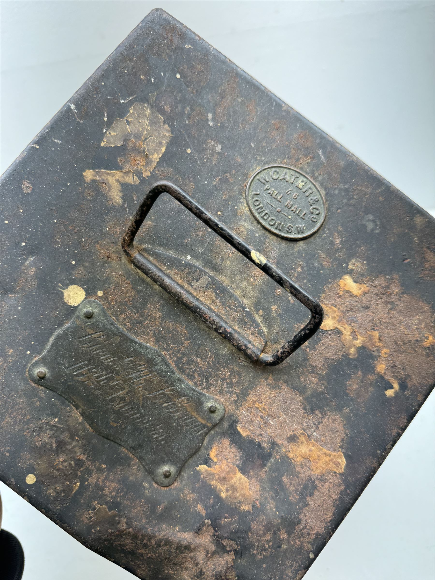 16th Queens Lancers Officers Lance Cap, black leather body with gilt braid lace and gilt wire braiding to the peak, officers silver gilt helmet plate to the front, the black cloth mortar board top with thick bullion wire, the bullion socket holder with embroidered GR cipher to the centre, lion head side bosses with velvet backed linked chinstrap, interior with leather sweatband and cloth lining, marked Carter & Co Pall Mall, the helmet is housed in japanned storage tin with brass plaque engraved “Lieu H L Evans, 16th Lancers'