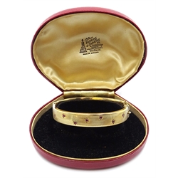  9ct gold hinged bangle set with rubies, engine turned decoration, Chester 1958  
