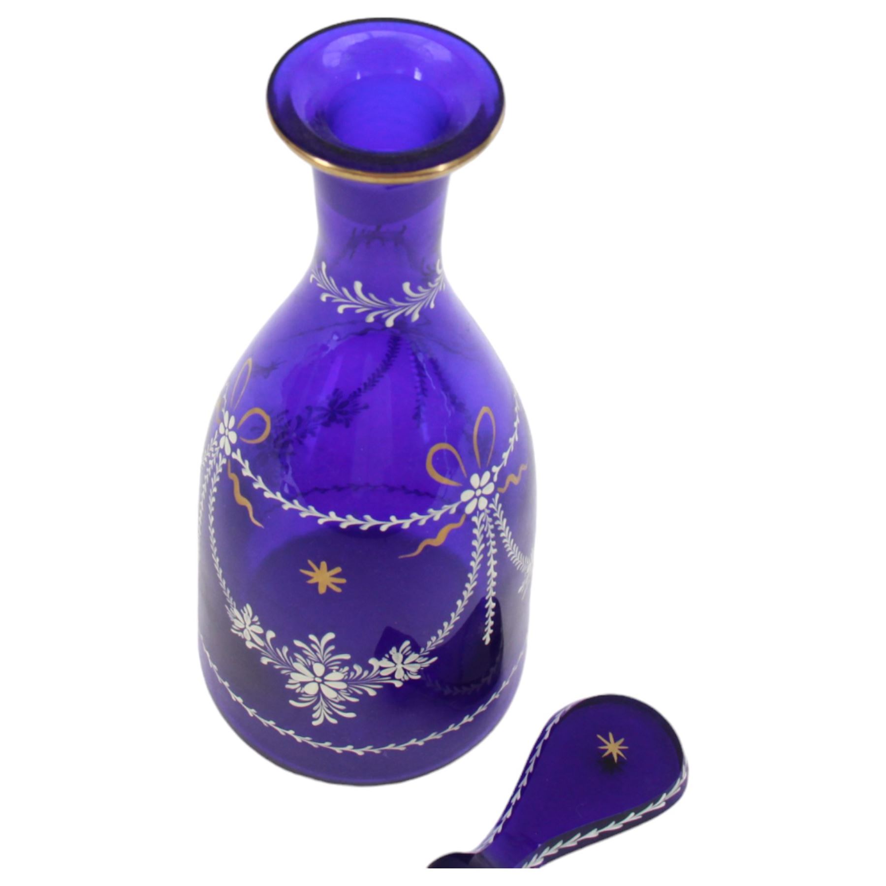 19th century style blue glass decanter and six drinking glasses, the decanter of mallet form with lozenge shaped stopper, all with white enamel and gilt swag decoration, decanter H34cm, drinking glasses H11.5cm
