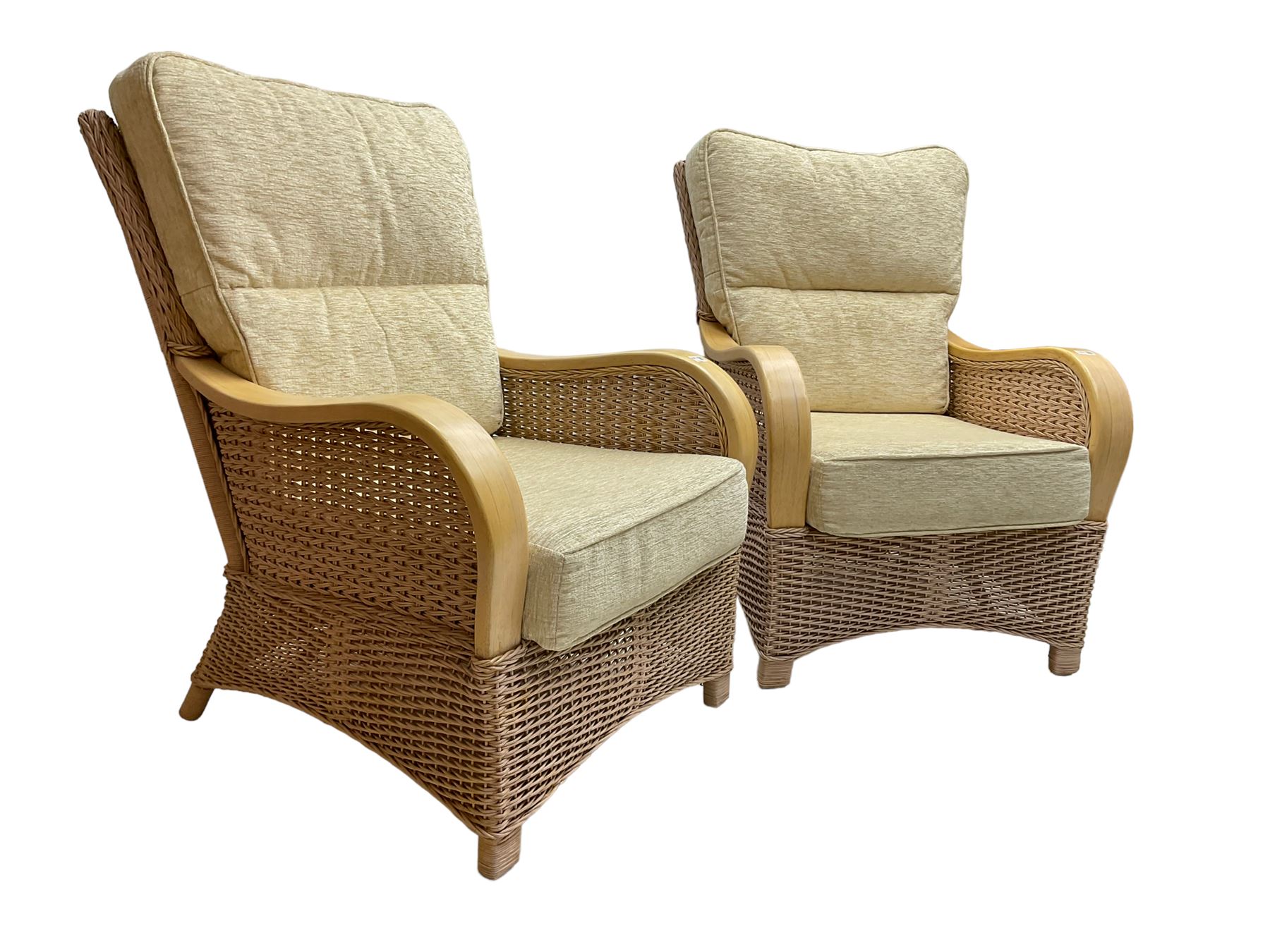 Contemporary rattan conservatory suite - two seat sofa with wicker frame and loose cushions upholstered in textured champagne fabric (W125cm H98cm); pair of matching armchairs (W72cm H98cm); rectangular glass-topped coffee table with rattan frame and undertier (W85cm D60cm H47cm); and matching square side table (W53cm H55cm)