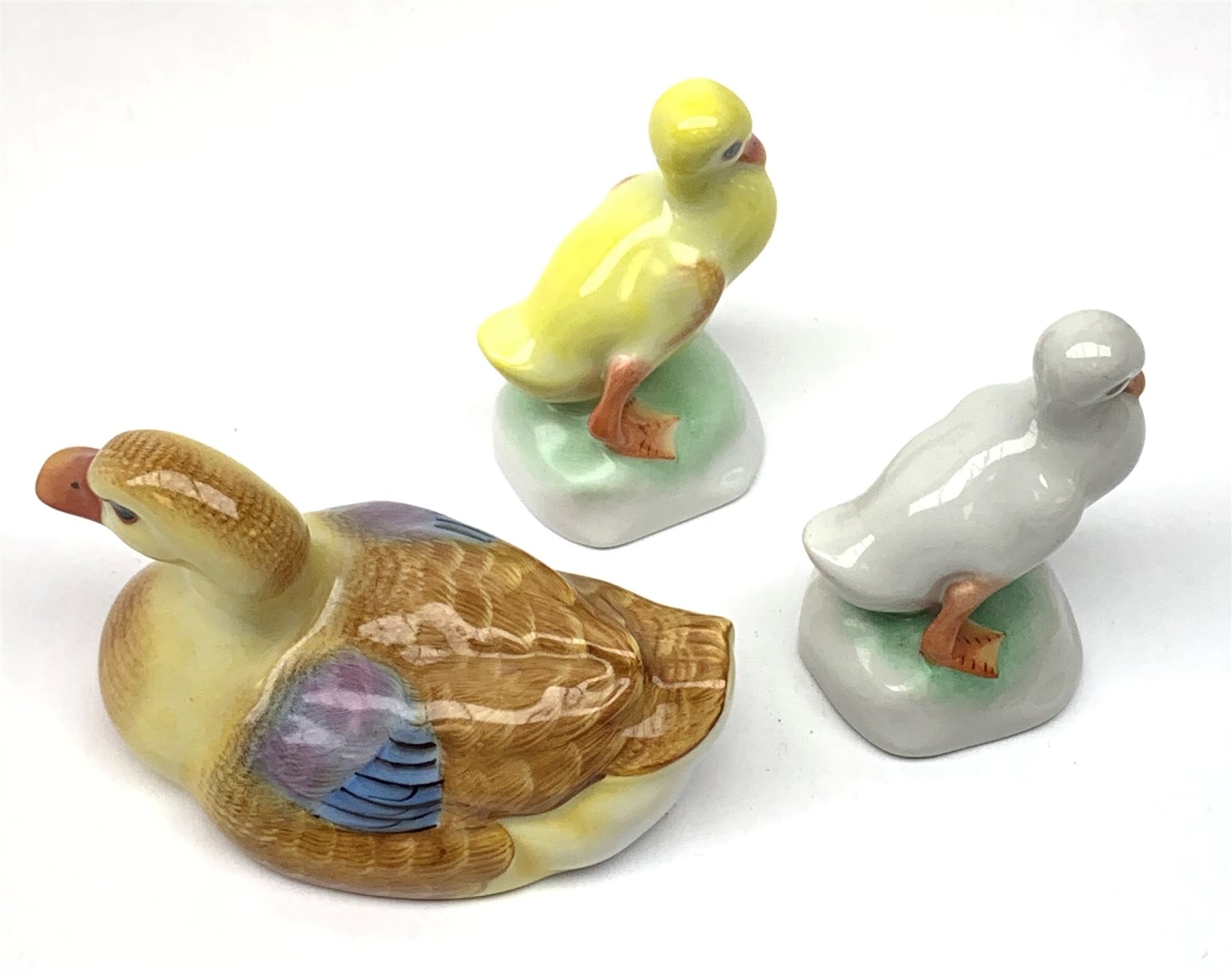 A Herend porcelain model of a Duck, together with two Herend Ducklings, each with printed mark beneath. 