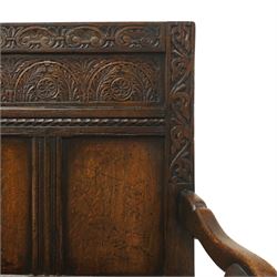 Victorian Jacobean Revival carved oak settle or hall bench with box seat, the cresting rail carved with repeating lunette motifs with acanthus and rosette decoration, over four back panels and hinged box seat, the panelled base raised on stile supports