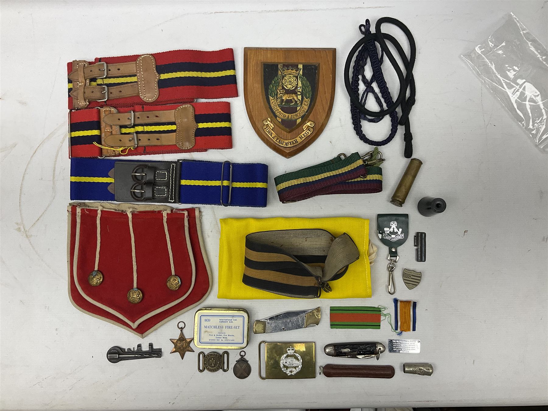 Miscellaneous militaria including two Royal Artillery and one Royal Horse Artillery stable belts; Northamptonshire Regiment trench art brass shell case lighter; unused Matchless Fire-Set; pocket knives and multi-tool; lanyards; oak shield with York & Lancaster crest etc