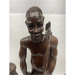 Pair of 20th century carved wood table lamp with African busts and figures, together with a carved wooden figure and soapstone figure, lamps H44cm