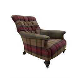 John Sankey - low armchair, buttoned back upholstered in tartan patterned fabric with contrasting grey leather, raised on turned and ebonised front feet with brass and ceramic castors, with matching foot stool