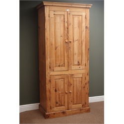  Traditional pine cupboard, projecting cornice, four cupboard doors, enclosing shelves, plinth base, W91cm, H198cm, D53cm  