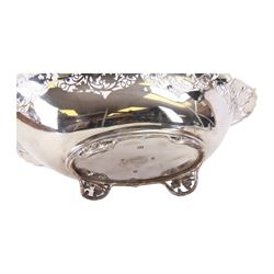 Early 20th century silver bowl, of oval form, the serpentine shaped edge with fruiting vine pierced and applied moulded decoration, upon four conforming fruiting vine feet, hallmarked Manoah Rhodes & Sons Ltd, Sheffield 1931, also bearing impressed mark Manoah Rhodes & Sons Lts Bradford, H11cm L34cm D19cm