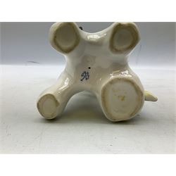 Karl Ens porcelain figure of a parrot, modelled with yellow breast, blue back and wings and green tail, perched upon on a blossoming branch, with blue printed factory mark beneath, H24.5cm