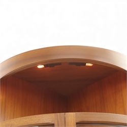 Nathan for Parker Knoll - corner cabinet, the upper section enclosed by two curved glazed doors with glass shelves, over a shaped base fitted with a single frieze drawer and panelled twin cupboard doors