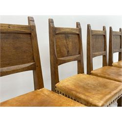 ‘Gnomeman’ set six adzed oak dining chairs, panelled backs, leather upholstered seats with studs, each carved with Gnome signature, four side chairs and two carvers, by Thomas Whittaker of Littlebeck