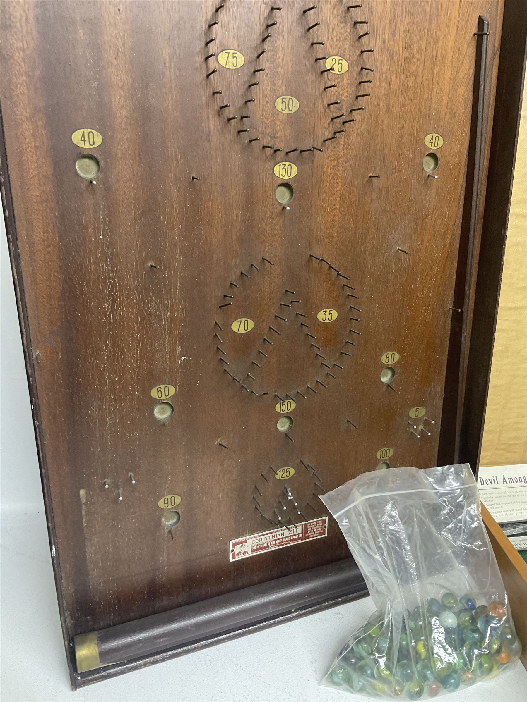 John Jaques and Son ‘Devil Among the Tailors’ wooden vintage skittles game, missing pole and ball, with instruction manual and original box; and a Corinthian Bagatelle board with marbles and push stick 