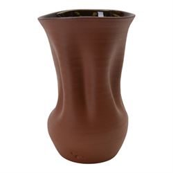 Nicholas Arroyave Portela (c1972-): earthenware vase with ribbed and crumpled surface covered in terracotta glaze to the exterior and brown glaze to the interior, impressed NAP mark, H22cm