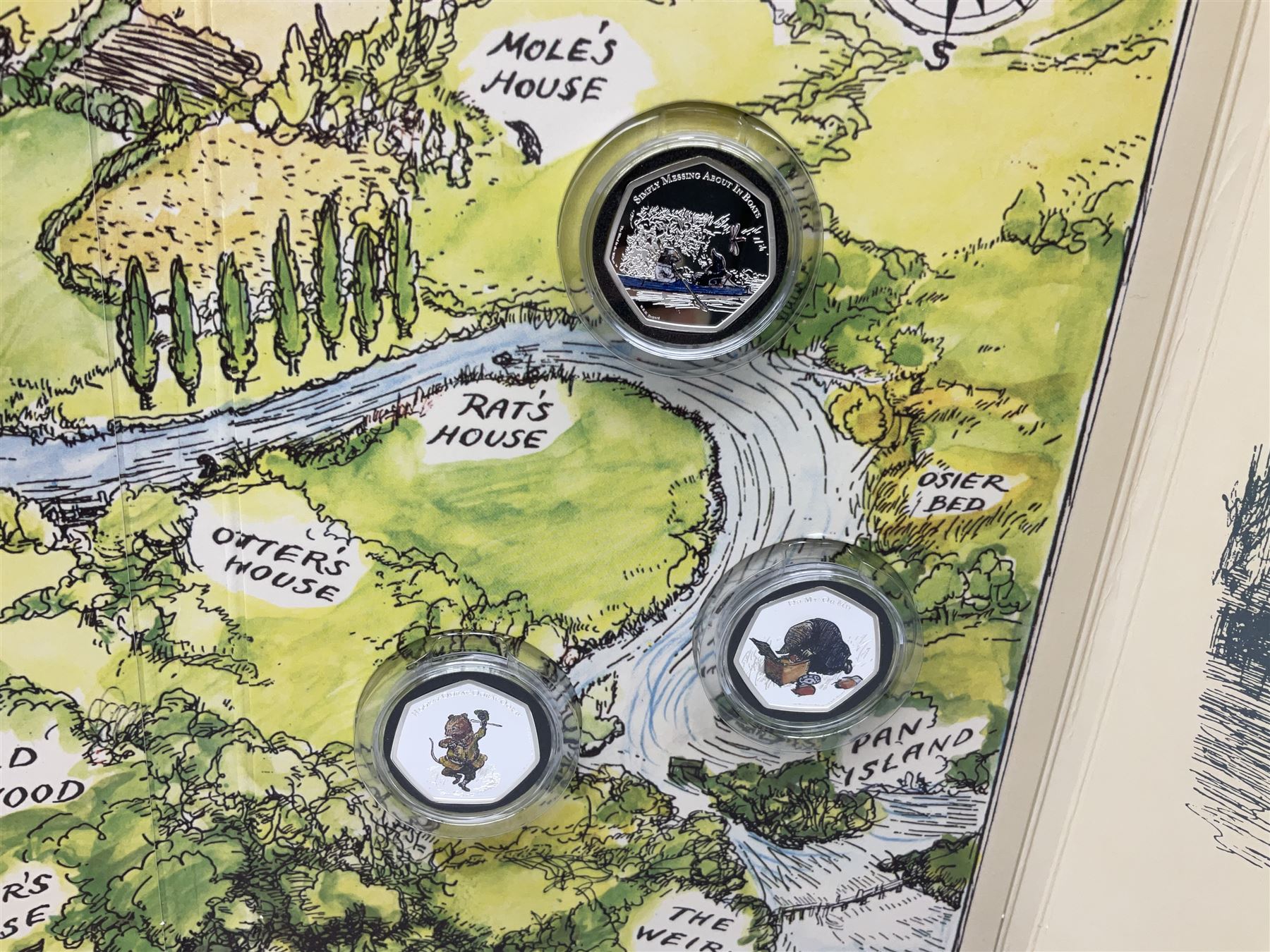 Two Queen Elizabeth II Ascension Island 2021 Wind in the Willows seven coin sets, both with 'Toad's Last Little Song' 24ct gold fifty pence weighing 2.25 grams, includes both layered in pure silver and fine .999 silver fifty pence pieces, housed in a presentation folders with certificates