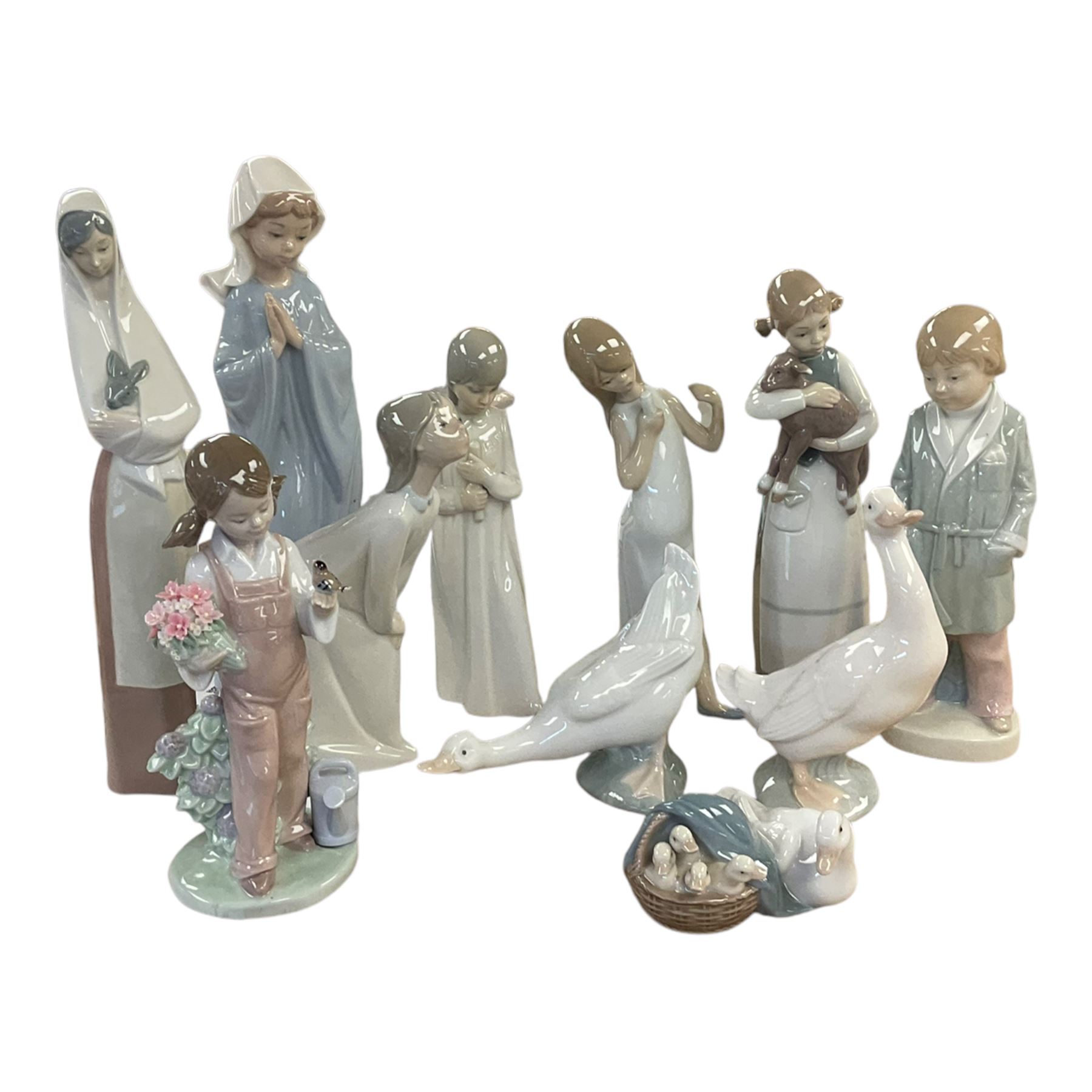 Four Lladro figures, including Girl holding bird no 5217, Duck and Ducklings no 4895 etc, together with Nao and similar figures 