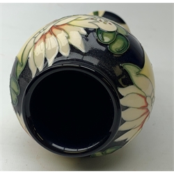 A Moorcroft Royal Wedding vase, of baluster form decorated with blossoming flowers on a dark blue ground, designed by Nicola Slaney, with impressed and painted marks beneath, H20.5cm.