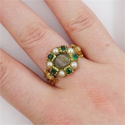 Georgian gold emerald and pearl mourning ring, the glazed central panel containing locket of hair, with emerald and split pearl surround, the shoulders and shank with foliate decoration, the underside of the head inscribed 'James Newcomb died 24 Jan 1820 aged 53 ys'