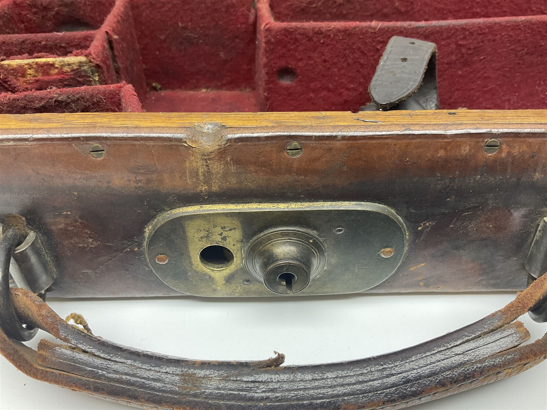 Leather shotgun case, the red baize lined interior with the trade labels of Westley Richards & Co., London, a brass plaque inscribed 'T Nevin, Mirfield, Yorkshire' to cover, with key, case to fit barrel 76cm (30 inches)  
