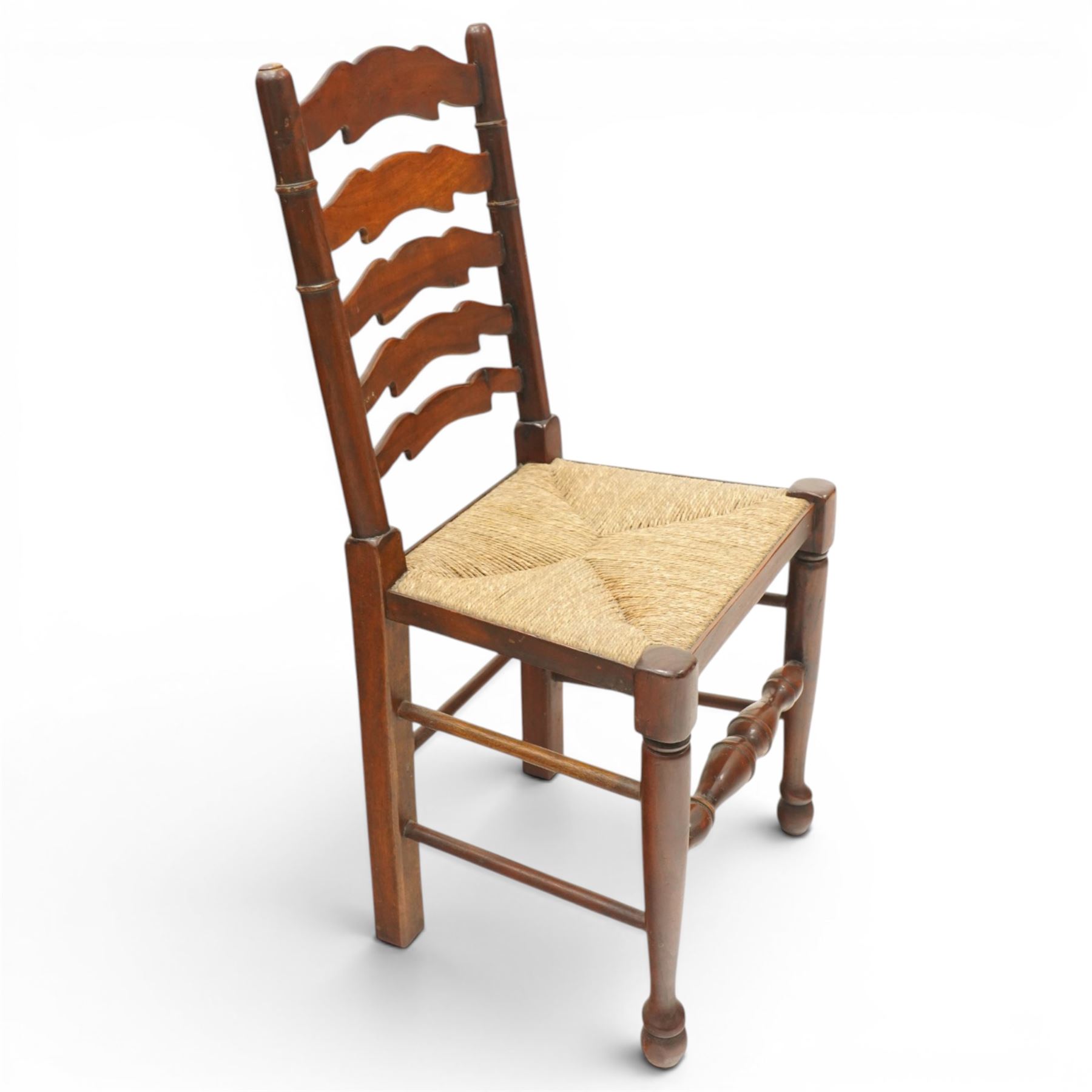 Set of six Lancashire country ladderback dining chairs with rush seats, raised on tapering supports with swell-turned stretcher