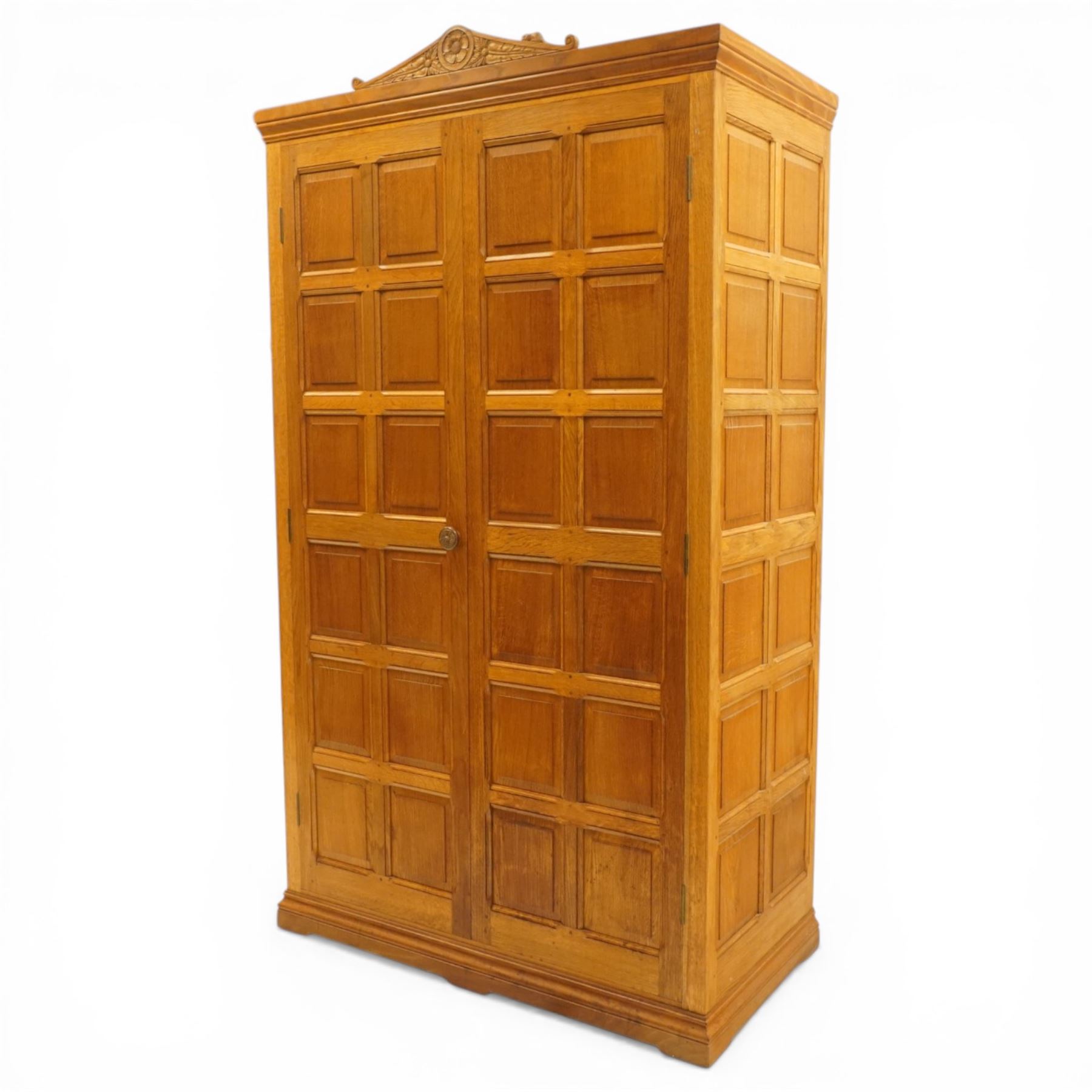 Beaverman - Yorkshire oak panelled double wardrobe, with carved pediment, panelled doors and sides, with internal top shelf above a single hanging rail, with carved beaver signature, by Colin Almack of Sutton near Thirsk