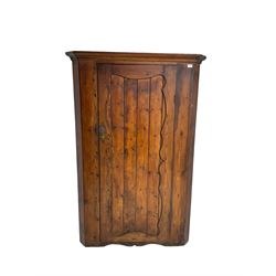 Late 19th century pine corner cabinet with shaped panelled door 