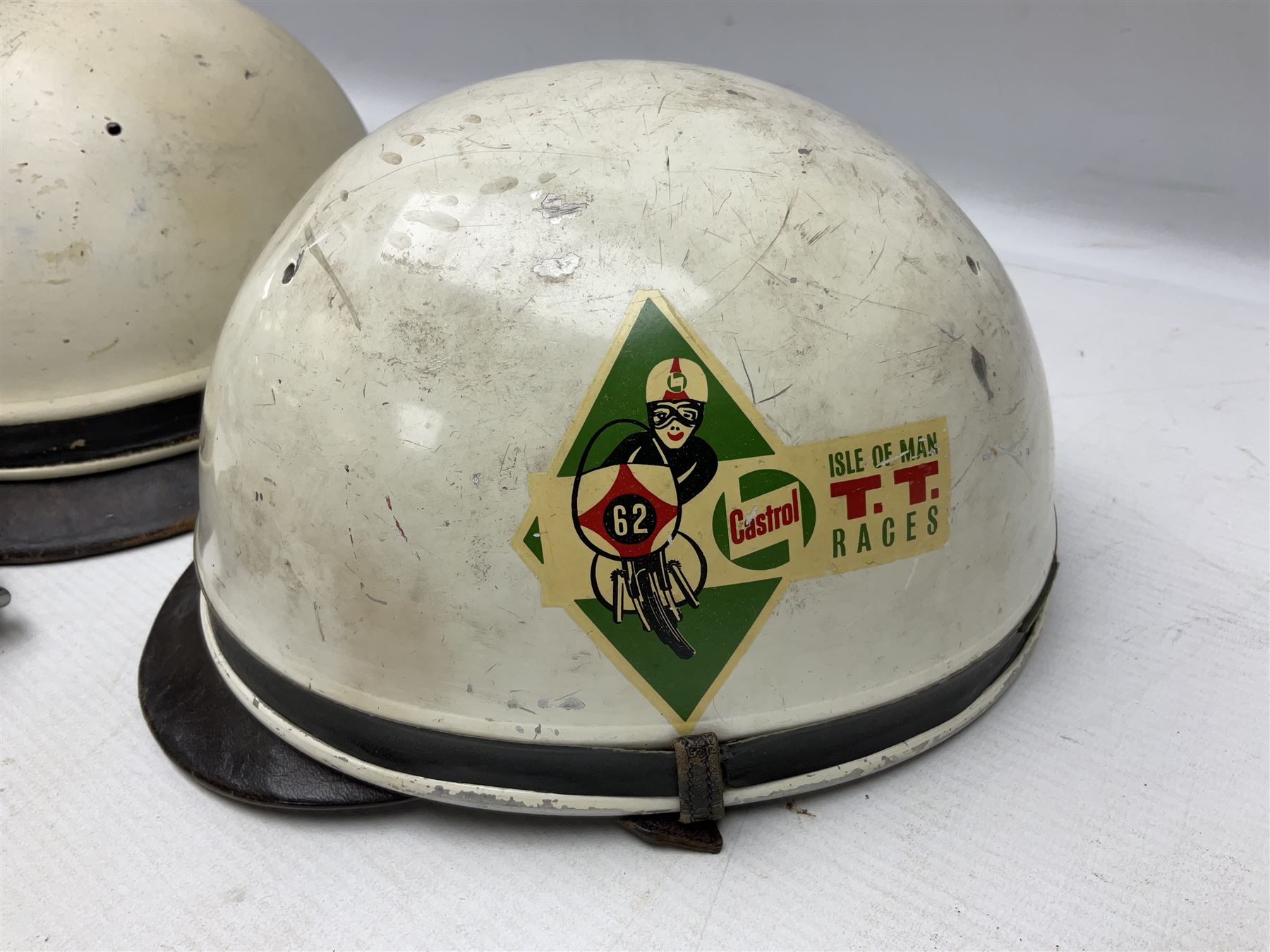 Two Geno Paris small size motorcycle helmets; and three pairs of goggles, one marked 'Stadium'