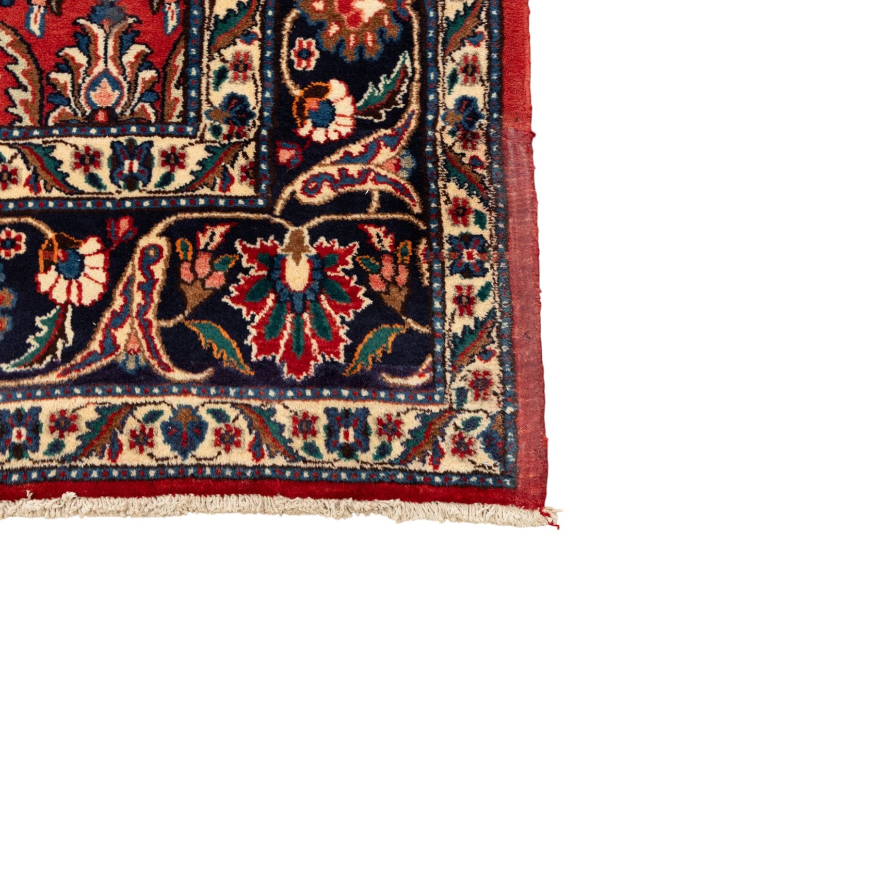 North West Persian carpet, the red field decorated with an all over repeating design of palmettes, rosettes and curling serrated leaves in indigo, ivory and ochre tones, enclosed by an indigo scrolling floral border and ivory flowerhead guard bands