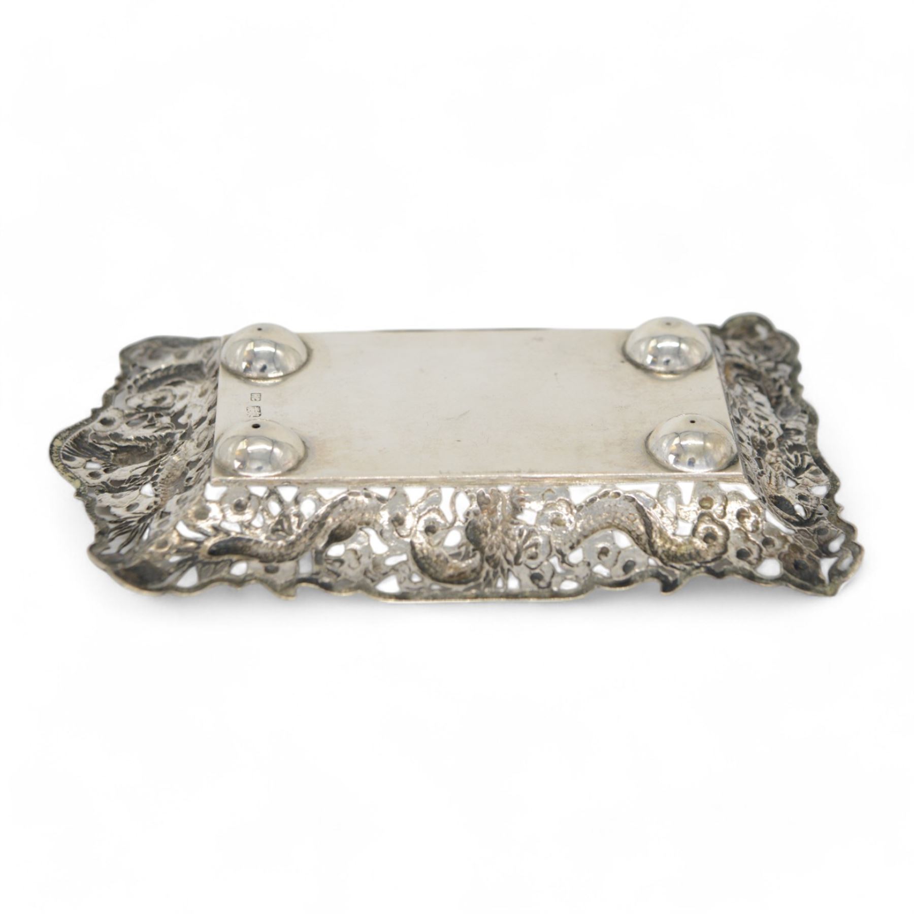 Chinese export pin tray, of rectangular form, the pierced sides embossed with dragons amongst flowers, stamped with character marks and maker's mark for Hungchong & Co, L13cm 