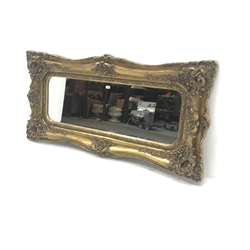 Large ornate bevel edge mirror in swept gilt frame, W184cm, H91cm