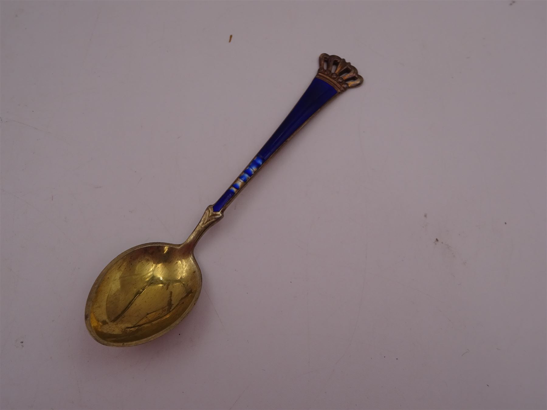 Set of six Danish silver-gilt blue enamel demitasse spoons with crown finials and together with an individually boxed example, all by Egon Lauridsen, stamped ELA Denmark Sterling 925S, both in fitted cases